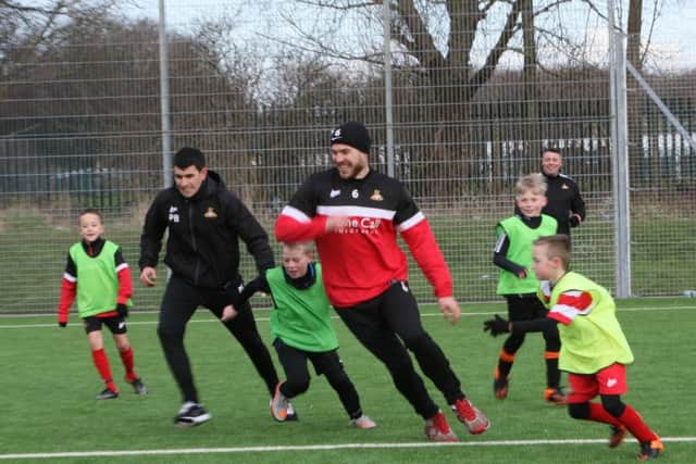Rovers first team coach Paul Butler and defender Andy Butler take part in half term coaching sessions