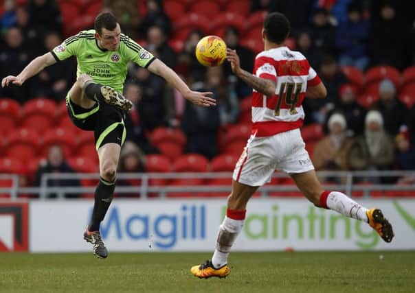 Neill Collins of Sheffield Utd clears under pressure from Nathan Tyson of Doncaster Rovers