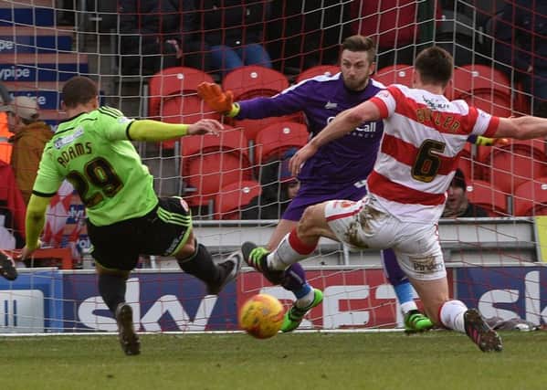 Che Adams scores. Pictures: Howard Roe and Sport Image
