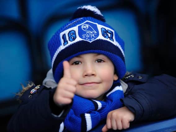 A young Owls fan gives the thumbs up to his side