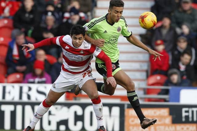 Dominic Calvert Lewin of Sheffield Utd tussles with Cameron Stewart of Doncaster Rovers