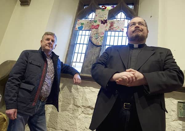 Vicar Mike Healy and church warden Michael Griffiths in St Mary's the Virgin Church at Beighton after arsonists struck