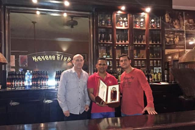 Cubana owners Brad Charlesworth (left) and Adrian Bagnoli (right) collecting their bottle of Maximo Extra Anejo from Havanna Club in Cuba