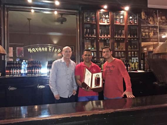 Cubana owners Brad Charlesworth (left) and Adrian Bagnoli (right) collecting their bottle of Maximo Extra Anejo from Havanna Club in Cuba