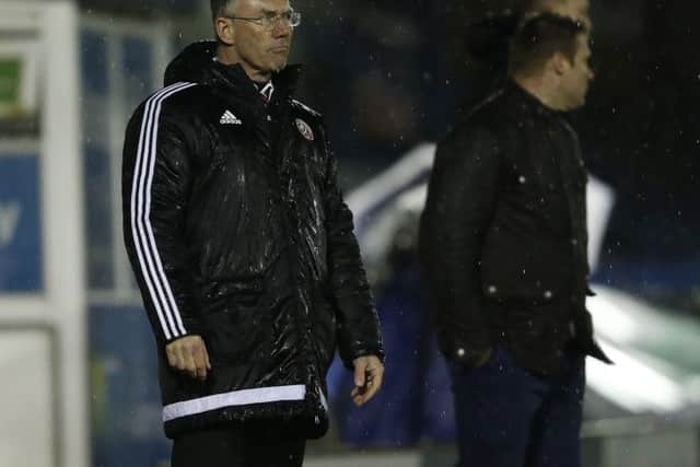 Nigel Adkins watches his side lose in the rain