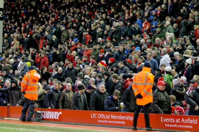 Liverpool fans walk out after 77 minutes during the Barclays Premier League match at Anfield