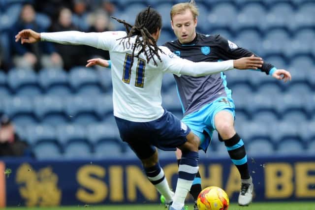 Barry Bannan battles for possession with Daniel Johnson