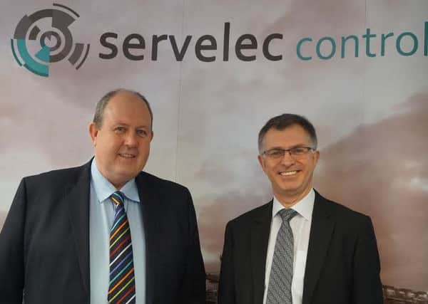 L to r:- Alex Moore, managing director for Servelec Controls Power & Nuclea, and Mike Tynan on the right.