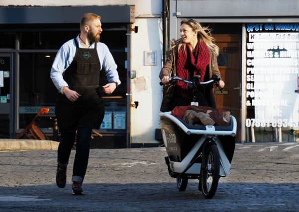 S-Cargo electric cargo bike launch: Harriet Grant from The Log Shop take a  test ride as Frank Forman from Recycle Bikes tries to keep up