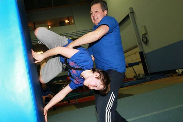 Alex Bourne, 13, has become hooked on freestyle gymnastic sessions held at Hillsborough Leisure Centre. Alex is pictured with coach Iain Simpson-Banks.