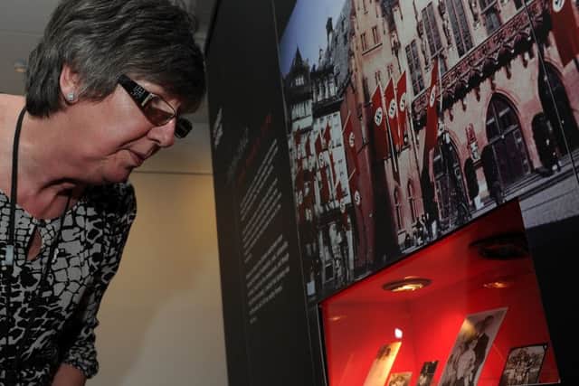 Yvonne Broadhead looks at photographs at the Anne Frank exhibition at the Riverside House, Rotherham. Picture: Andrew Roe