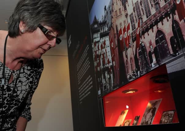 Yvonne Broadhead looks at photographs at the Anne Frank exhibition at the Riverside House, Rotherham. Picture: Andrew Roe