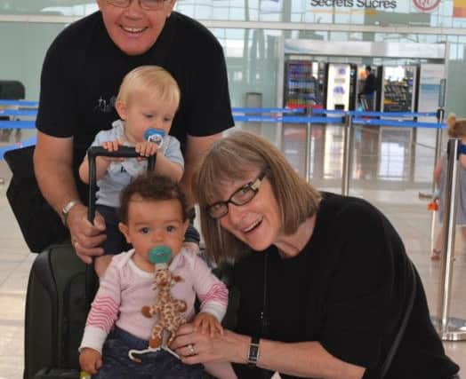 Ruth and Alan at the airport with two of their grandchildren