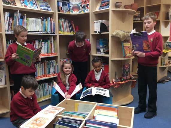 Pupils from Prince Edward Primary School reading in the schools new library.