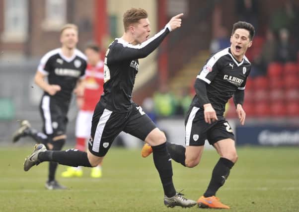 Alfie Mawson celebrates the goal whch gave  Barnsley the win at Gresty Road. Photo: Keith Turner
