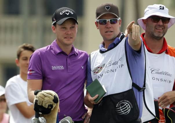 Danny Willett chats with his caddie Jonathan Smart, on the 10th tee during the first round of the Cadillac Championship