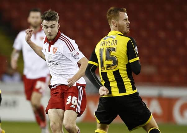 Ben Whiteman of Sheffield Utd  passes past Tom Naylor of Burton Albion on his Blades debut on Tuesday