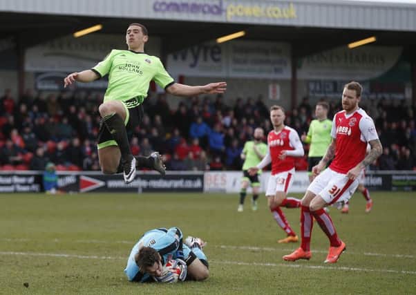 Chris Maxwell of Fleetwood Town saves as Che Adams of Sheffield Utd closes in