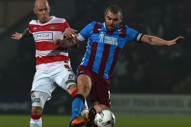 Richard Chaplow tussles with Stephen Dawson during last night's 2-0 defeat to Scunthorpe. Photo: Andrew Roe