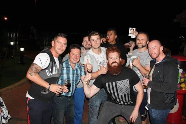 Brad Flash, left, with other wrestlers relaxing after a match.
