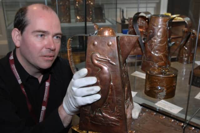 PAGE 8 (RUN THRU) James Massey collections assistant of Cannon Hall Museum, Cawthorne near Barnsley with on of the many jugs in the exhibition 'useful and beautiful' with objects made of copper at the Newlyn school of Industrial Art 1890 to 1930   See story  by Jeni Harvey  Picture Chris Lawton 8th September  2008