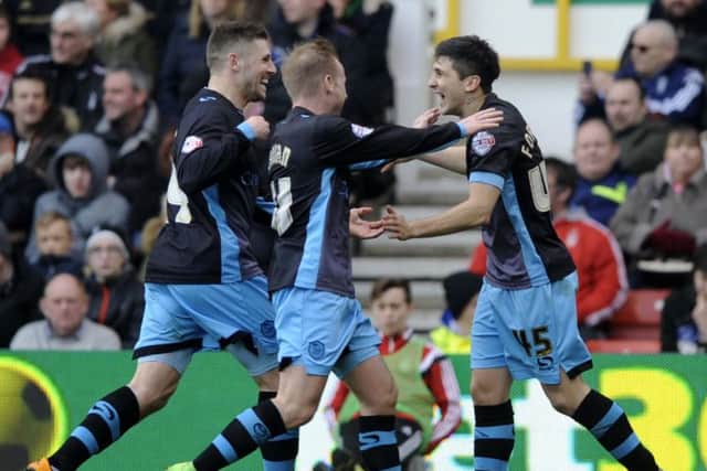 Gary Hooper and Barry Bannan rush to thank goal provider Fernando Forestieri after the second at the City Ground