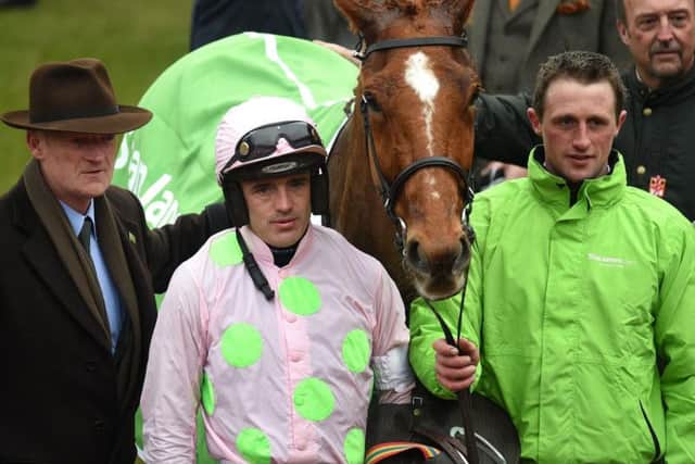 Jockey Ruby Walsh (2nd left) and trainer Willie Mullins (left) celebrate winning the Stan James Champion Hurdle Challenge Trophy with Annie Power during Champion Day of the 2016 Cheltenham Festival at Cheltenham Racecourse. PRESS ASSOCIATION Photo.