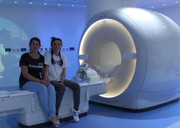 Teresa and Ebony Taylor by the new MRI machine
