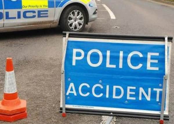 Emergency services have closed a busy Doncaster road, following a one-vehicle collision that left the car on its side and two people trapped.