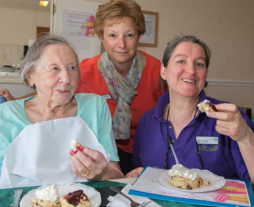 Cherry Mawhood, Lynn Walter, and Christine Gomersall tuck in to a cream tea to help break a world record at The Laurels Care Home in Fulwood