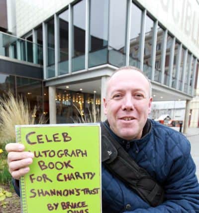 Bruce Davis who is collecting celebs' signatures in an autograph book to raffle off in aid of the Shannon Bradshaw Trust charity.