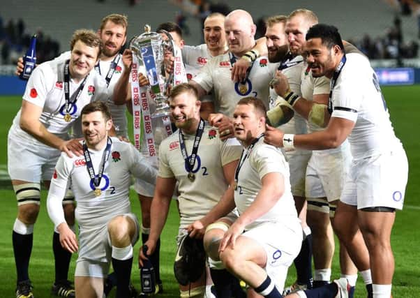 England celebrate with the RBS 6 Nations trophy after beating France 31-21  at the Stade de France, Paris to complete the Grand Slam. Photo: Andrew Matthews/PA Wire.