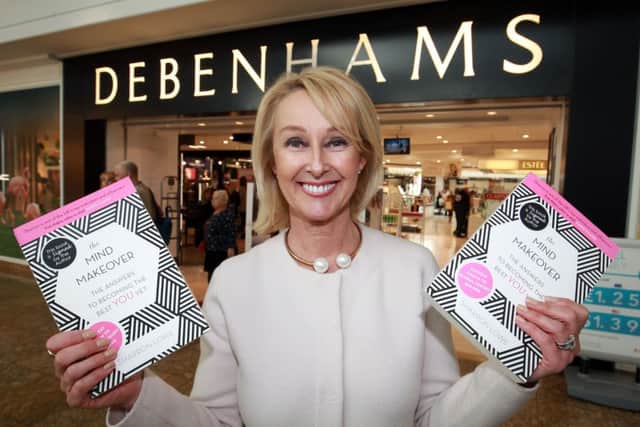Author and life coach Sharron Lowe pictured with her book The Mind Makeover outside Debenhams in Meadowhall.