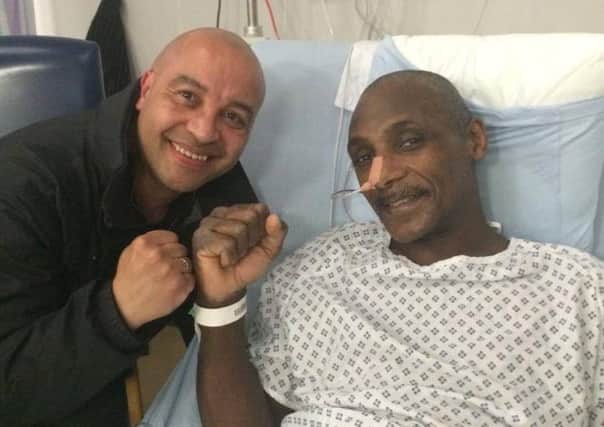Sheffield-trained boxer Herol Graham recovers from a burst appendix in hospital with friend Andy Brace.