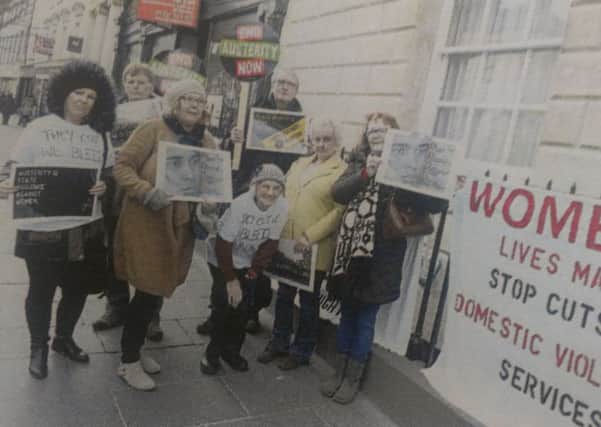 Doncaster Women's Aid campaigners protest outside the Mansion House in Doncaster.