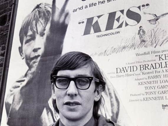 A young Barry Hines in front of an iconic film poster of Kes