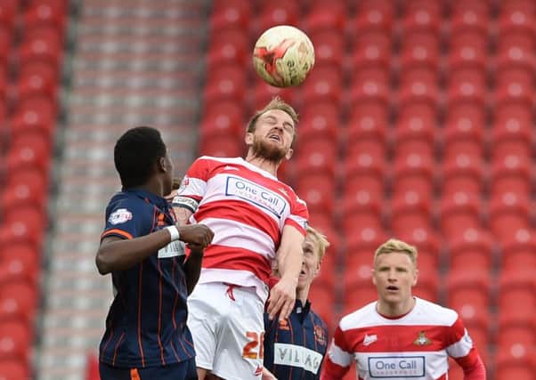 James Coppinger looks to win an aerial battle during Rovers' damaging defeat to Blackpool