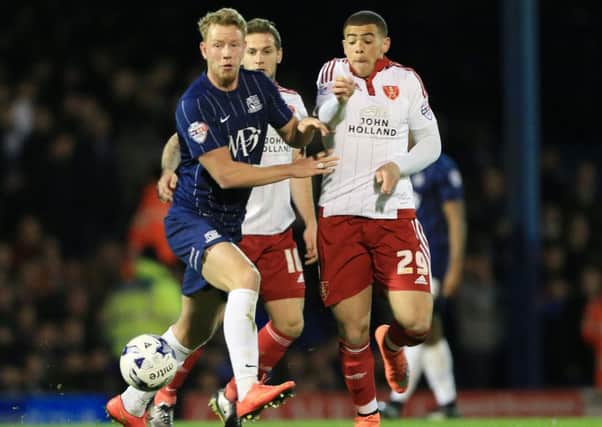 Adam Thompson tussles with Sheffield United's Che Adams