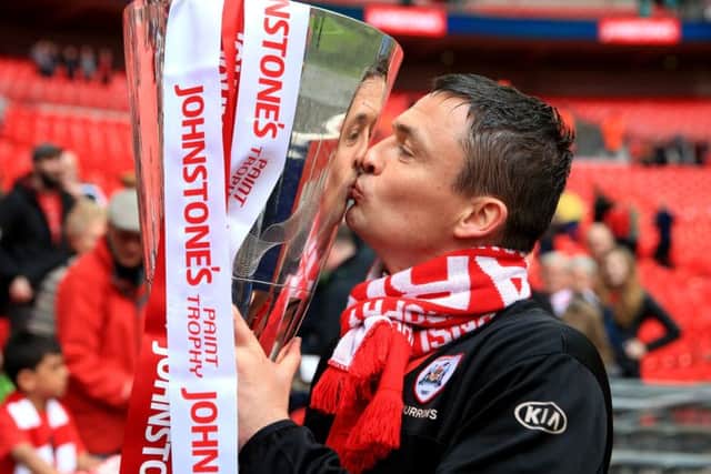 Barnsley manager Paul Heckingbottom celebrates with the Johnstone's Paint Trophy . PIC: PA