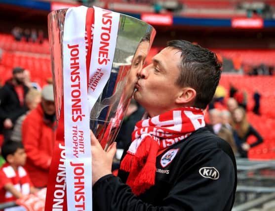 Barnsley manager Paul Heckingbottom celebrates with the Johnstone's Paint Trophy . PIC: PA