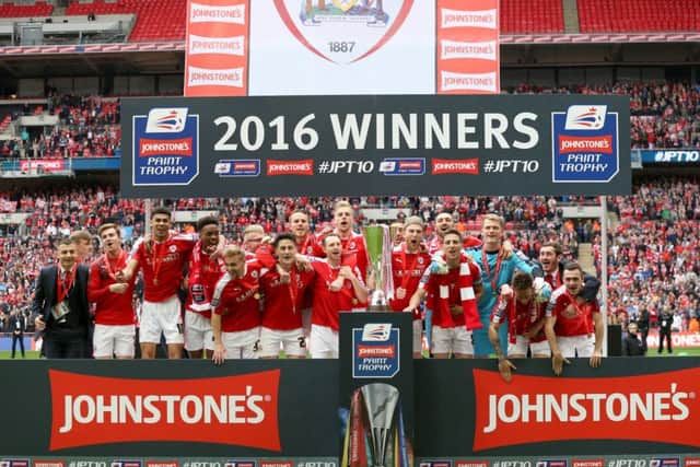 Barnsley players celebrate with the Johnstone's Paint Trophy at Wembley Stadium