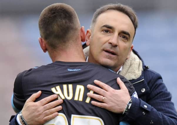 Carlos Carvalhal hugs Owls'  ex-Huddersfield player Jack Hunt at the final whistle on Saturday. Photo: Steve Ellis