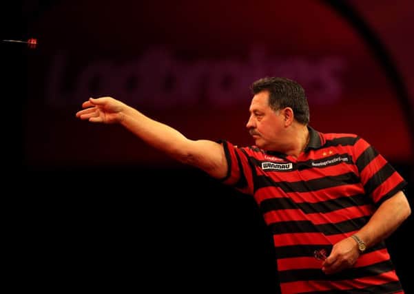 Dennis Priestley in action during the Ladbrokes.com World Darts Championship back in, 2012.
