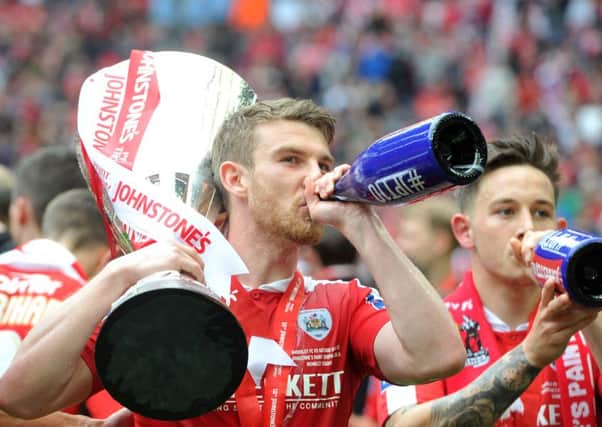 Sam Winnall celebrates with the Johnstone's Paint Trophy and a bottle of bubbly
