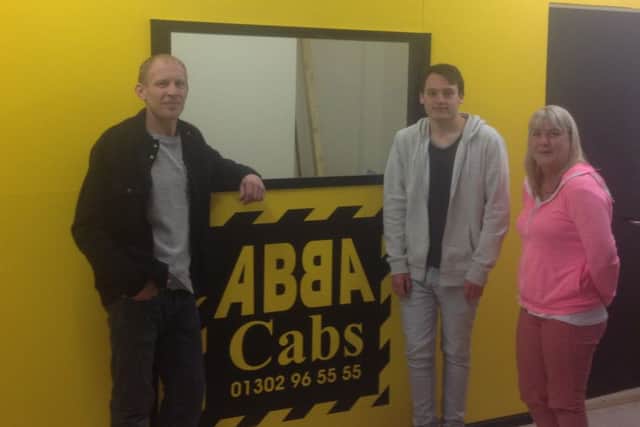 Abba Cabs has opened a new town centre office. Left to right are owners David lilley and Ryan Waugh and driver Marie Stevens.