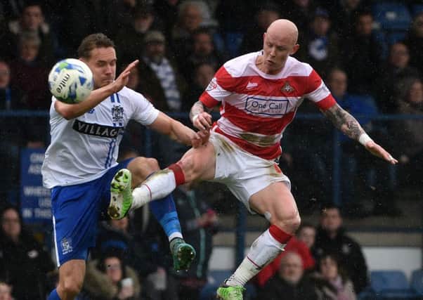 Richard Chaplow contests a ball with Bury's Chris Hussey