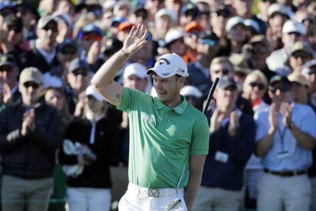 Danny Willett, of England, celebrates on the 18th hole after finishing the final round of the Masters
