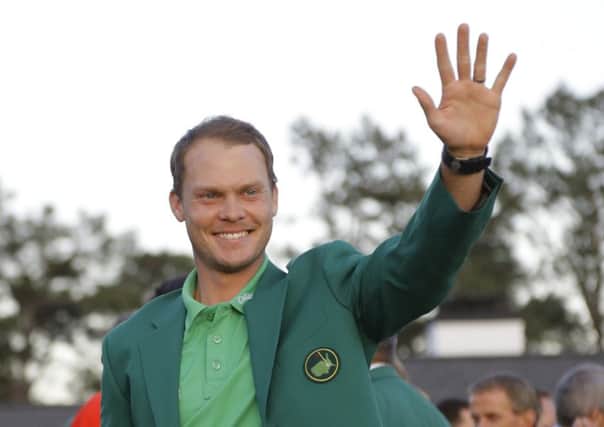 Master champion Danny Willett, of England, waves after winning the Masters golf tournament Sunday, April 10, 2016, in Augusta, Ga. (AP Photo/Jae C. Hong)