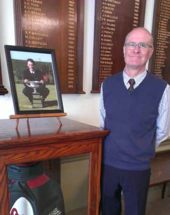 Rotherham Golf Club chairman Chris Allen with Danny Willet's photo and golf bag in the clubhouse
