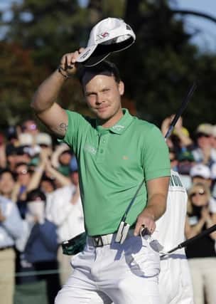 Danny Willett, of England, waves to the gallery after putting out on the 18th hole during the final round of the Masters golf tournament Sunday, April 10, 2016, in Augusta, Ga. (AP Photo/David J. Phillip)